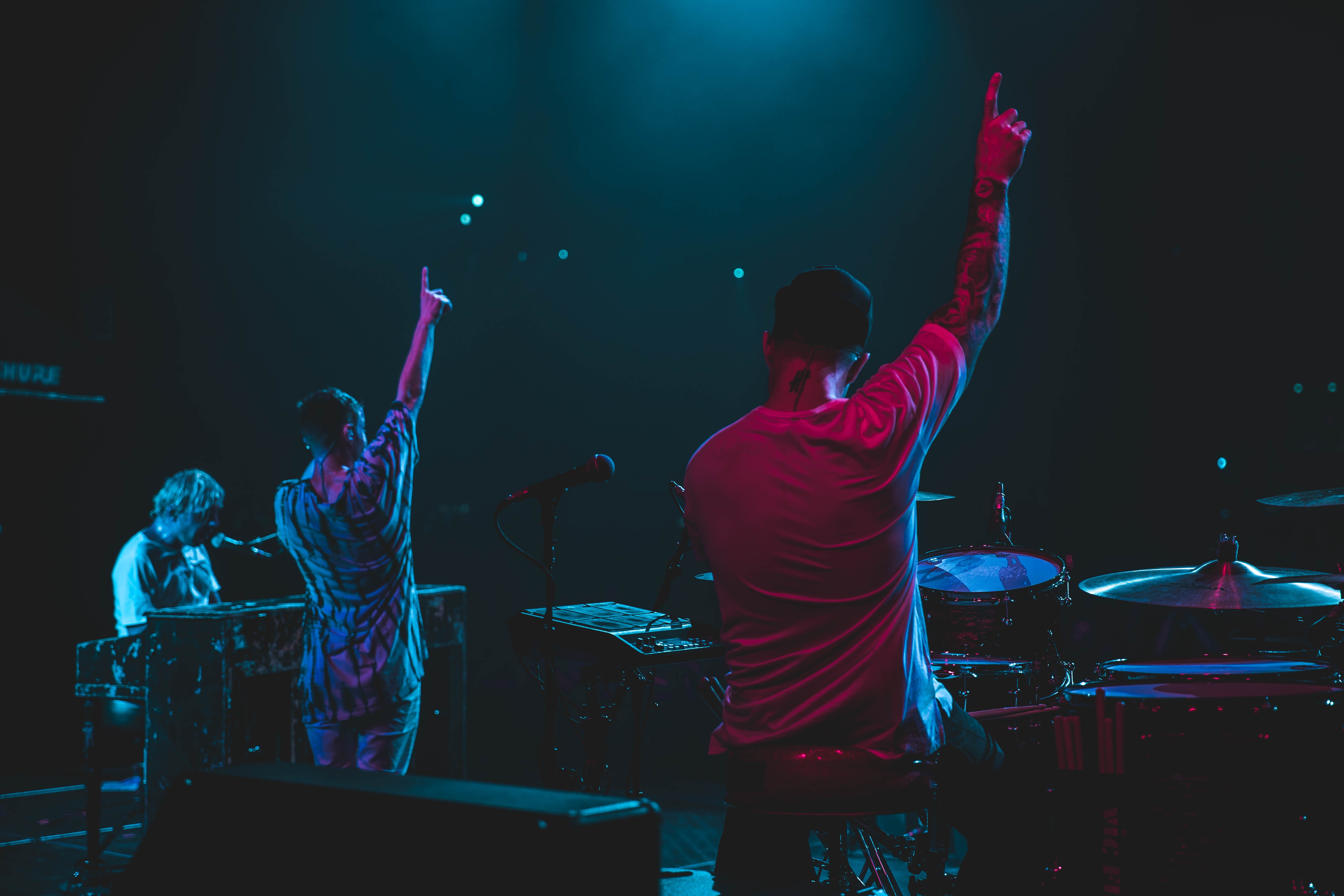 musicians pointing at a crowd of people